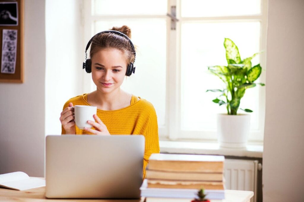 A woman working from a laptop at home as a legal transcriptionist.