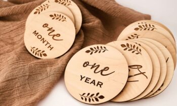 An assortment of laser-cut signs arranged on a table.