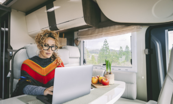 Female digital nomad working her online 1099 job in her van