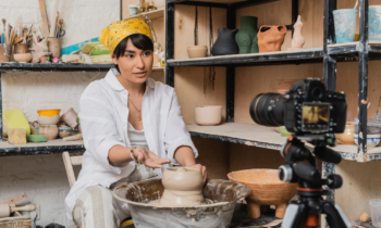 Female pottery maker filming social media content