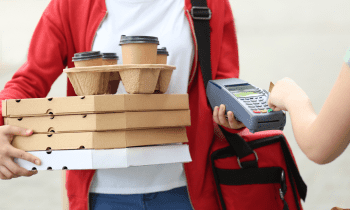 Woman delivering coffee and pizza to a customer