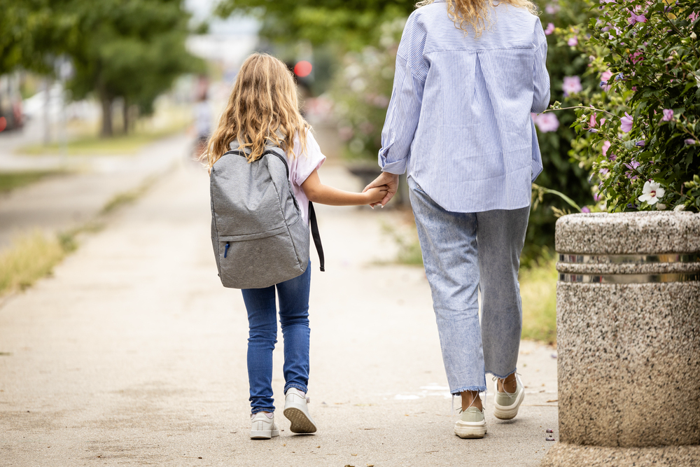 Mom walking daughter to school for blog post jobs during school hours