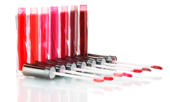 Tubes of red and pink lip gloss ready to sell online in a lip gloss business store