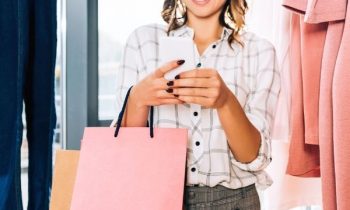 Woman using smartphone app while shopping - The Best Apps That Pay You for Receipts