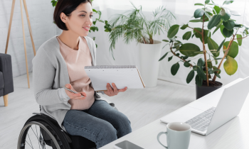 woman in a wheelchair working from home