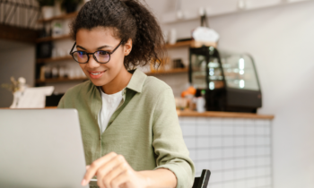 Woman on her laptop searching for online test scoring jobs