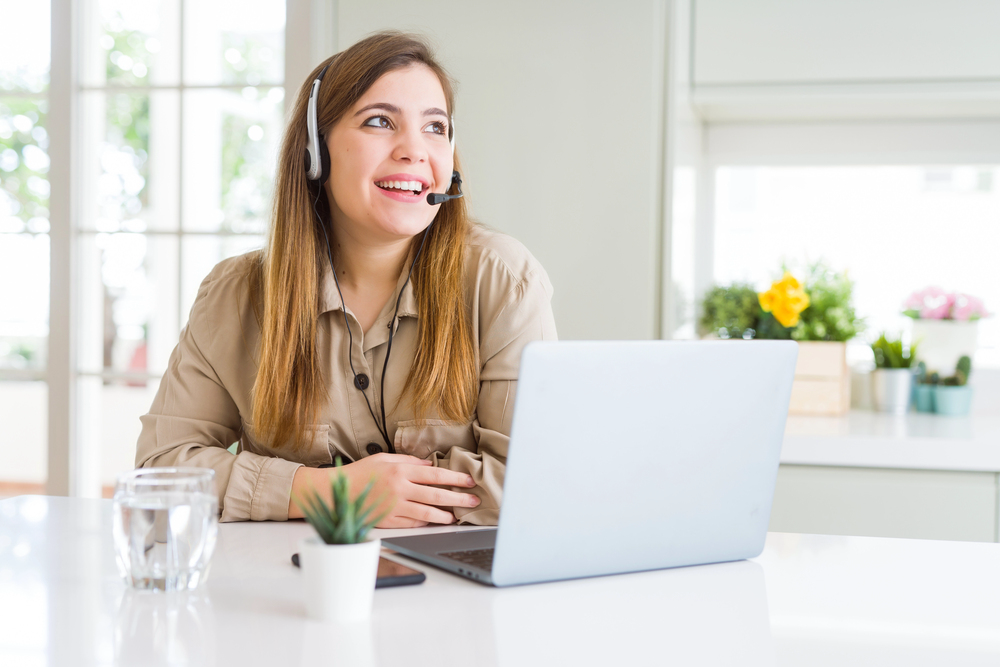 Woman taking calls for her Alorica work from home job