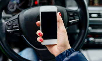 Woman using a mobile app to make money with a car