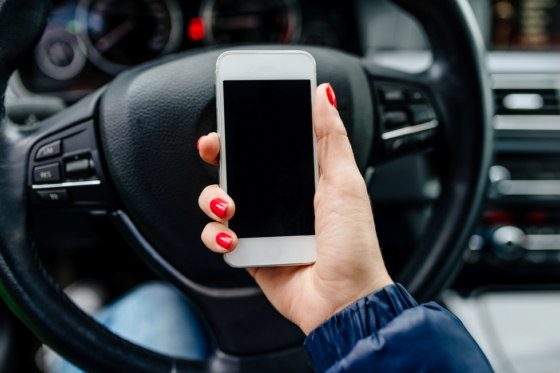 Woman using a mobile app to make money with a car