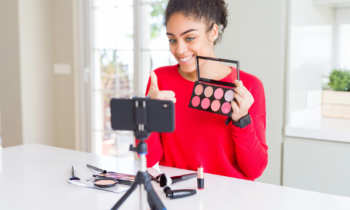 Young female Amazon Influencer filming a review video on makeup