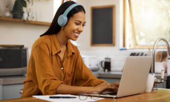 Young woman reading a rev review on her laptop