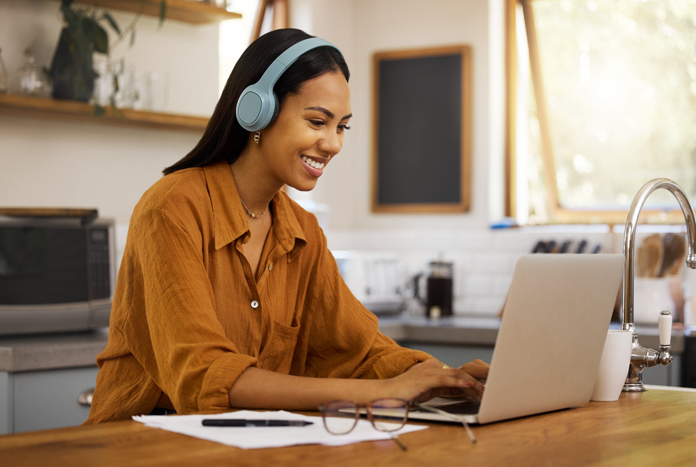 Young woman reading a rev review on her laptop