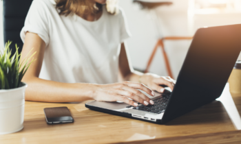 Young woman working at home on her laptop doing her data entry jobs